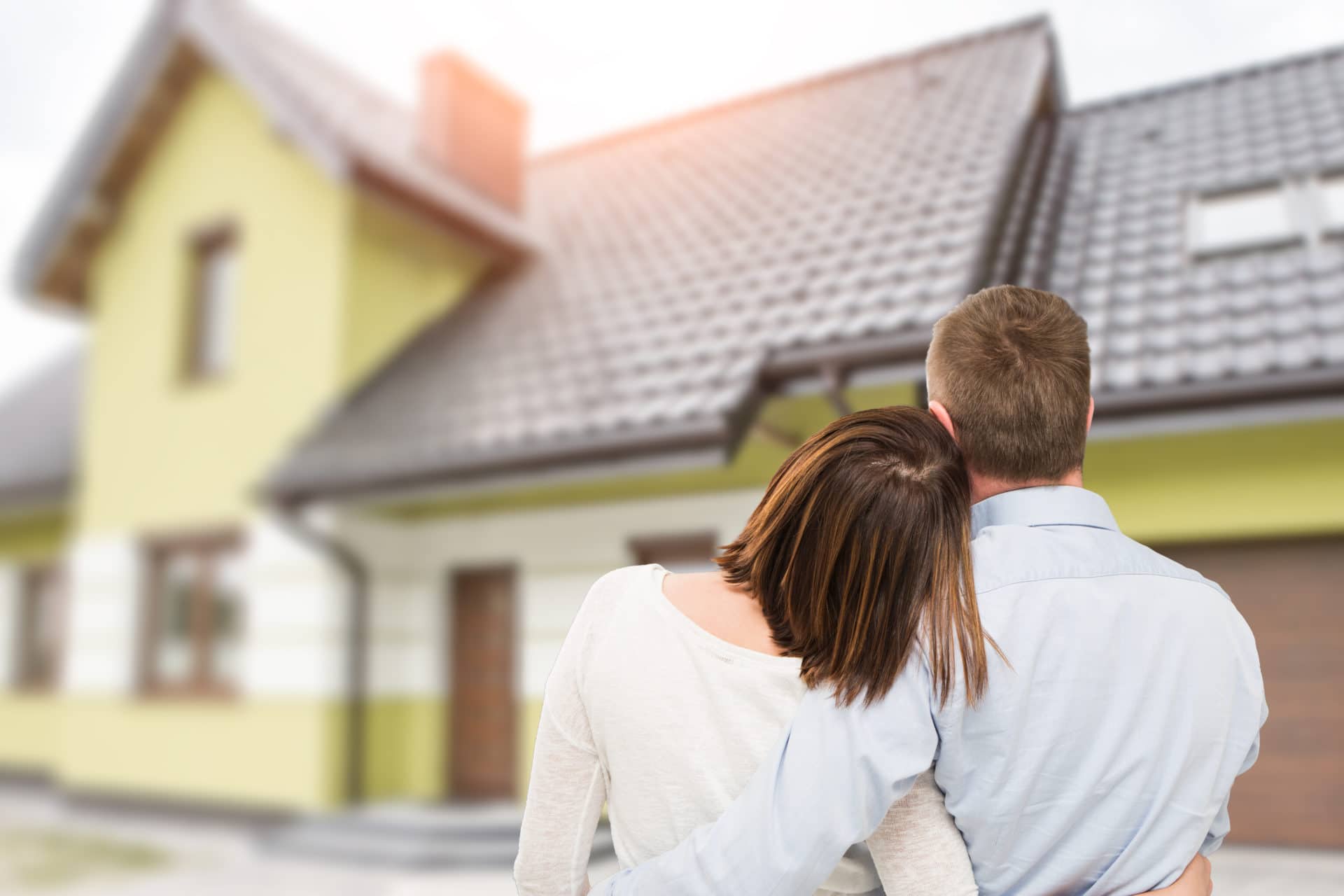 Young Couple Looking At Dream House